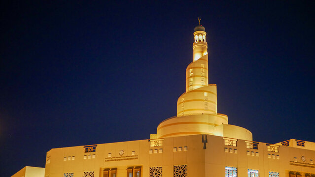 Doha, Qatar - March 19, 2025: Abdullah Bin Zaid Al Mahmoud Islamic Cultural Center (Fanar Mosque) illuminated at night in Doha city.