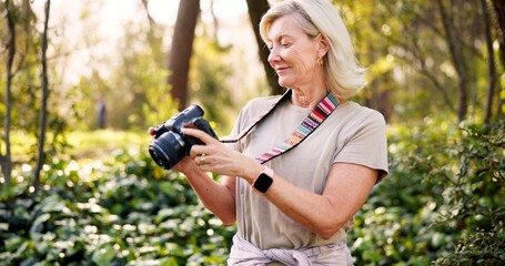 Mature woman, photographer and camera in forest with smile, check and creativity for nature magazine. Journalist, photography and decision for project, research and ideas for conservation in Brazil © peopleimages.com