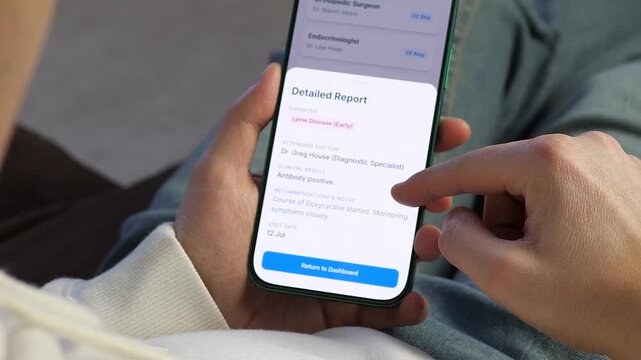 Patient Reviewing Positive Lyme Disease Diagnosis in Medical App. Close-up of a patient viewing a detailed medical report on a smartphone. Screen displays early Lyme disease diagnosis and doctor notes