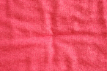 Fototapeta premium Red fabric textile material surface with texture and folds