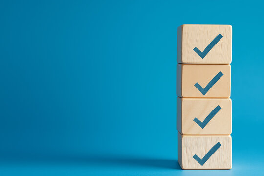 Checklist concept. Correct sign tick check mark on wooden block with copy space for the checklist on blue background. Business survey questionnaire, Exam test process