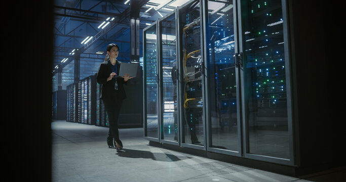 IT engineer uses a laptop to check and monitor server equipment. Software diagnostics, internet connectivity, and technical service support for stable infrastructure and system performance. 