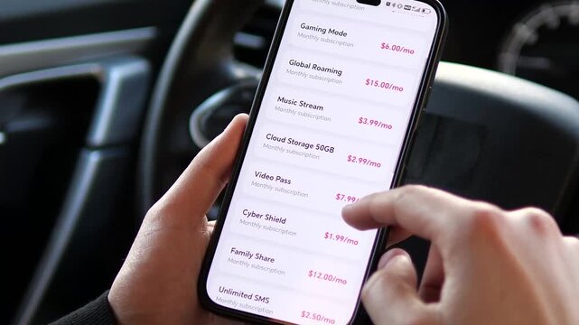 Person in car scrolling through modern mobile service app subscriptions. High-quality footage of a user browsing mobile plan add-ons like 5G speed, roaming, and cloud storage on a smartphone. 