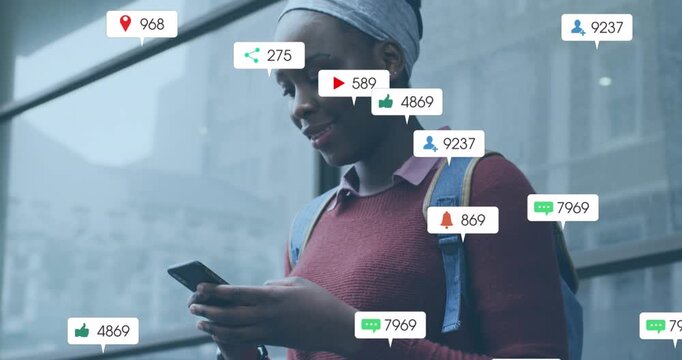 Animation of social media icons with growing numbers over african american woman using smartphone