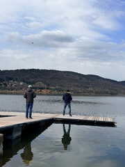 Fototapeta premium Vergiate, Italy - March 18, 2026: Collection of remote controlled seaplanes arranged on a lakeside dock, ready for flight. Detailed scale models used for hobby aviation and outdoor recreation.