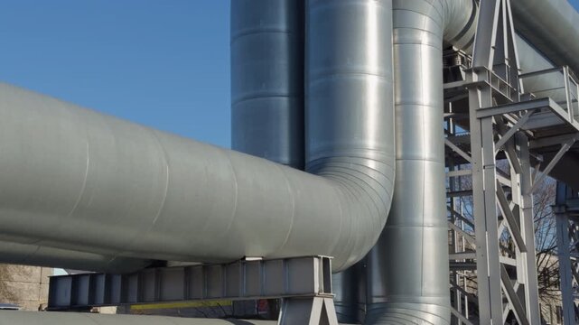 Closeup view of insulated pipe bend with support. Technical examination of heavyduty conduit with welded seams and support bracket