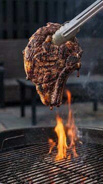 Grilled steak searing meat over open flame and smoke on backyard outdoor barbecue grill juicy ribeye lifted by metal tong above hot charcoal cooking scene with rustic char and tender texture