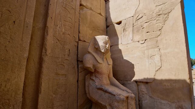 Karnak Temple in Luxor, Egypt. Close-up two ancient Egyptian pharaoh statues with ankh symbol at Karnak Temple, Luxor Egypt. Stone sculptures against blue sky. Authentic history and travel content.