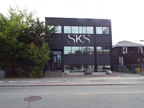Ottawa, Ontario, Canada-July 22, 2025: The "SKS Law office" building features a modern black brick facade and prominent signage along at 725 Churchill Avenue North in Westboro.