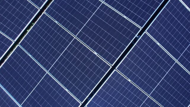 Cinematic aerial footage of photovoltaic solar panels for clean energy.