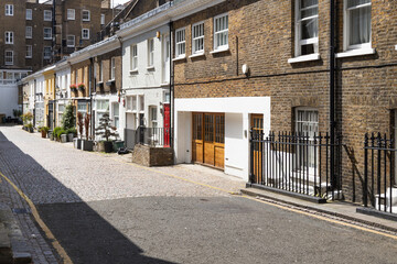 Fototapeta premium Traditional brick mews houses on a quiet street in London.