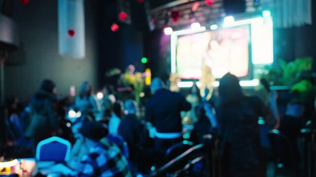 Energetic crowd revels brightly. Enthusiastic attendees are captivated by energetic performance and vibrant lighting display