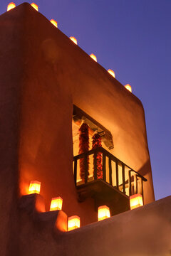 Santa Fe, New Mexico, United States. Tradional farolitos light up adobe structures.