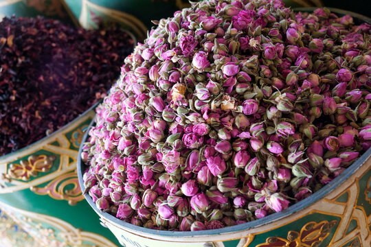 Marrakech, Morocco Close up of dried rose buds in bowl at Moroccan spice market