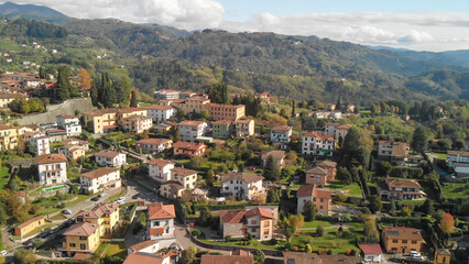 Fototapeta premium Aerial view of Barga, Garfagnana, showcasing the picturesque Italian village on a sunny day