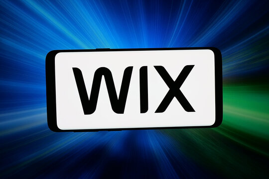 Stuttgart, Germany - 03-16-2026: In this photo illustration, the logo of Israeli software company Wix.com Ltd. is displayed on a smartphone in front of abstract background on computer screen.