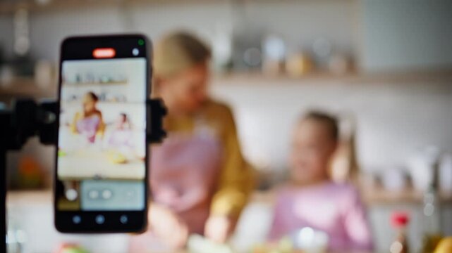 Food bloggers family recording smartphone in kitchen closeup. Mom child cooking