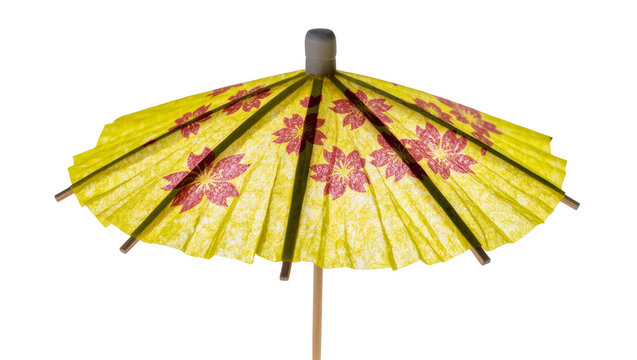 Isolated vibrant yellow paper cocktail umbrella with delicate red cherry blossom pattern for summer drinks