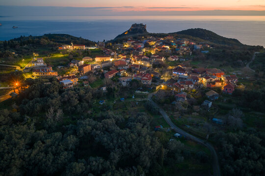 Majestic aerial view of Krini village architecture and Angelokastro fortress ruins at sunset with calm sea background in Corfu island Greece