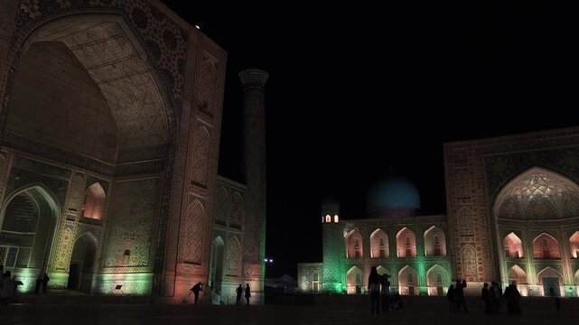 Stunning night panorama of Registan Square with illuminated grand portals of Ulugbek and Tilya Kori madrasas. Minarets, turquoise mosaic, glowing arches. Islamic architecture, Samarkand, Uzbekistan.