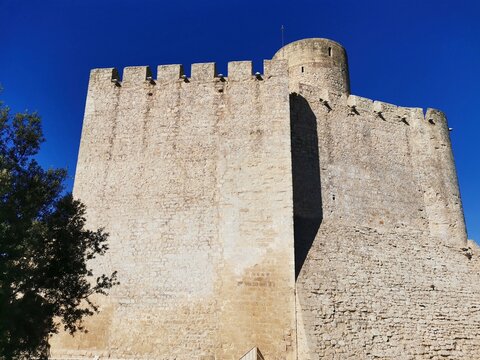 Close-up of medieval stone battlements and tower of Castellet Castle.