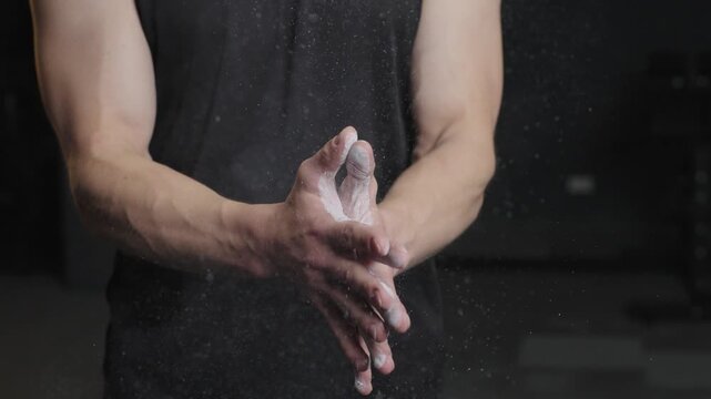 Barbell training at the gym with chalk on hands and focus on lifting techniques for strength building