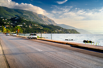 Coast Greek island Corfu with cars and mountains in morning light. © Tomasz