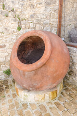 Obraz premium Traditional Stone Village Street with Large Clay Pot, Lofou, Cyprus