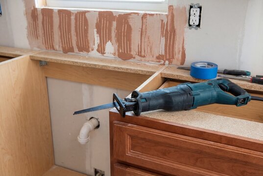 Reciprocating saw on kitchen counter during renovation
