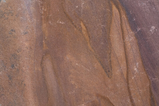 Brown sandstone texture with natural mineral streaks abstract earthy background