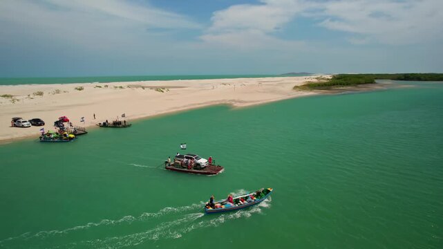 Aerial view of boats and ferry on a tropical river