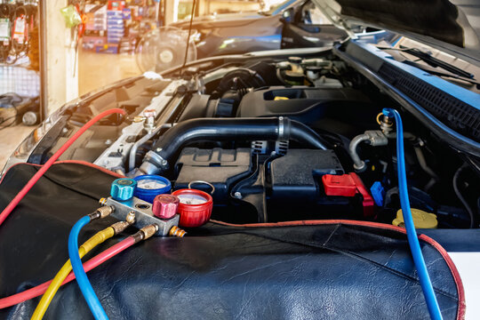 A/C Manifold Gauges Set. Check pressure and leak for use air conditioning systems. Recharging car air conditioner with refrigerant using grade gear with separate gauges to monitor pressure in system.