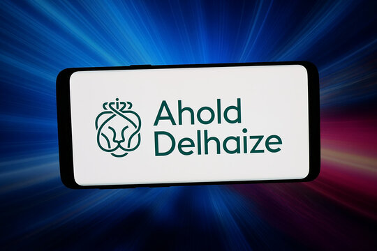 Stuttgart, Germany - 03-16-2026: In this photo illustration, the logo of Dutch company Koninklijke Ahold Delhaize N.V. is displayed on a smartphone in front of abstract background on computer screen.