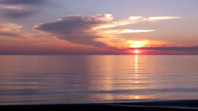 Sunset over calm ocean water 4K Footage Video Clip