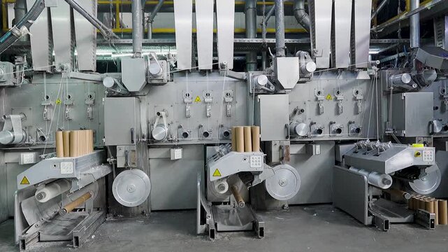 Industrial automated carpet manufacturing machinery in a large textile factory production line