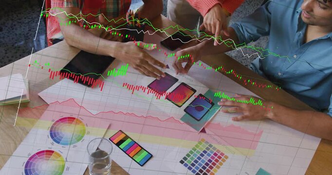 Designers reaching for mocks and tracing layouts to refine UI while data charts moving above table
