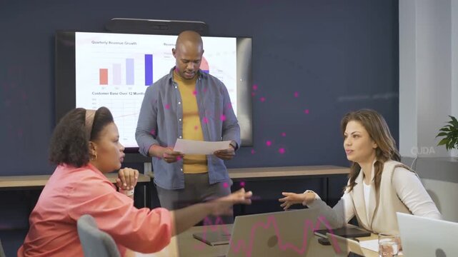 Standing man reading business report and asking team pointing at laptop as charts updating, closing