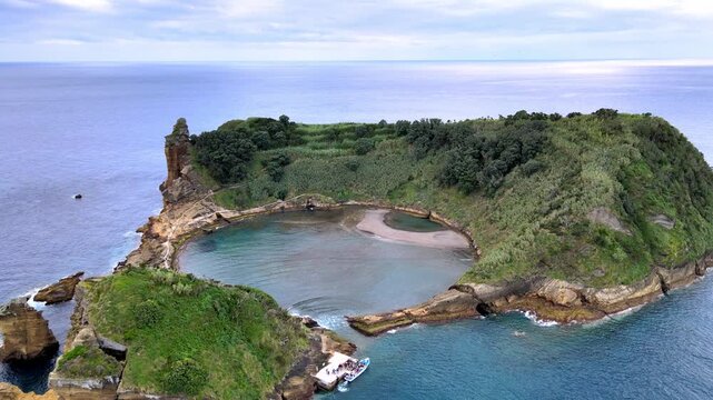 Aerial drone view of the volcanic islet Vila Franca do Campo near S&atilde;o Miguel Island, Azores, Portugal. The circular volcanic crater forms a natural lagoon protected from the Atlantic Ocean, surrounded