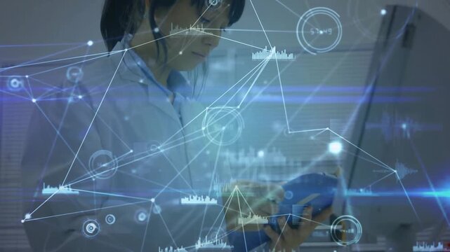 Researcher bringing blue tool near monitor rotating while data overlay showing lab graphs for study