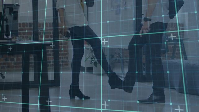 Colleagues foot-tapping and trading folder in office, teal grid overlaying, donning mask for health