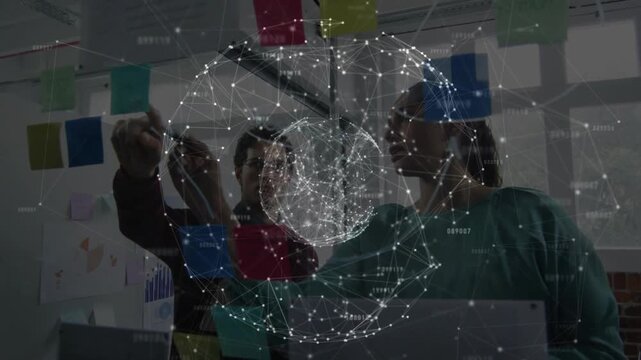 Man reaching placing blue sticky note pair moving notes under rotating sphere using laptop agreeing