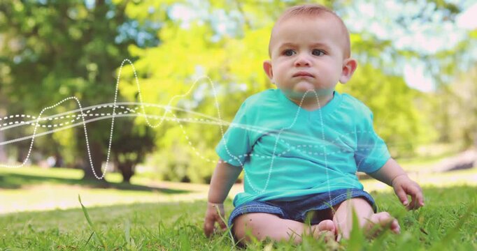 Vertical video: Infant reaching on grass as dotted waveform overlay crossing lower third for health