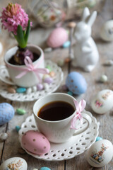 Easter is a holiday, with painted eggs bearing the inscription "Christ is risen." A cup of coffee flower are on the table.