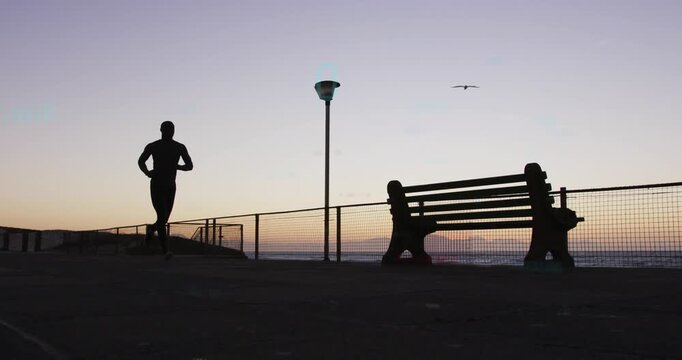 Vertical video: Dawn urging runner jogging left to bench and lamp for fitness as bird crosses sky