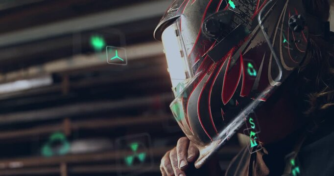 Welder gripping and tilting visor, lowering, overlaying visor with green AR icons preparing to weld