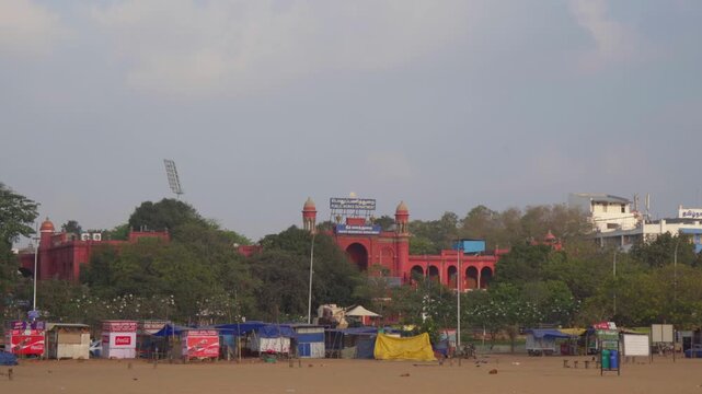 Wide Establishing Shot of the Historic Red PWD Building from Marina Beach, Chennai