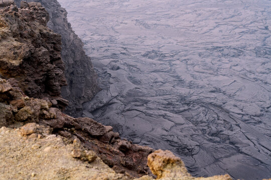 Lava lake crater and solidified flow at Erta Ale Volcano, Danakil Depression, Ethiopia