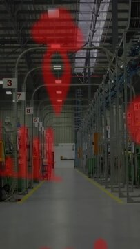 Vertical video: Factory worker walking down aisle, red pins and arcs growing over worker and posts