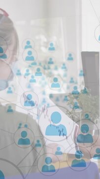 Vertical video: Business analyst holding report scanning charts, headset, icons overlaying teamwork