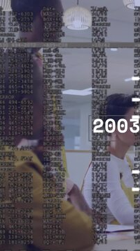 Vertical video: Standing woman and two seated team watching pitch, timeline scrolling over table